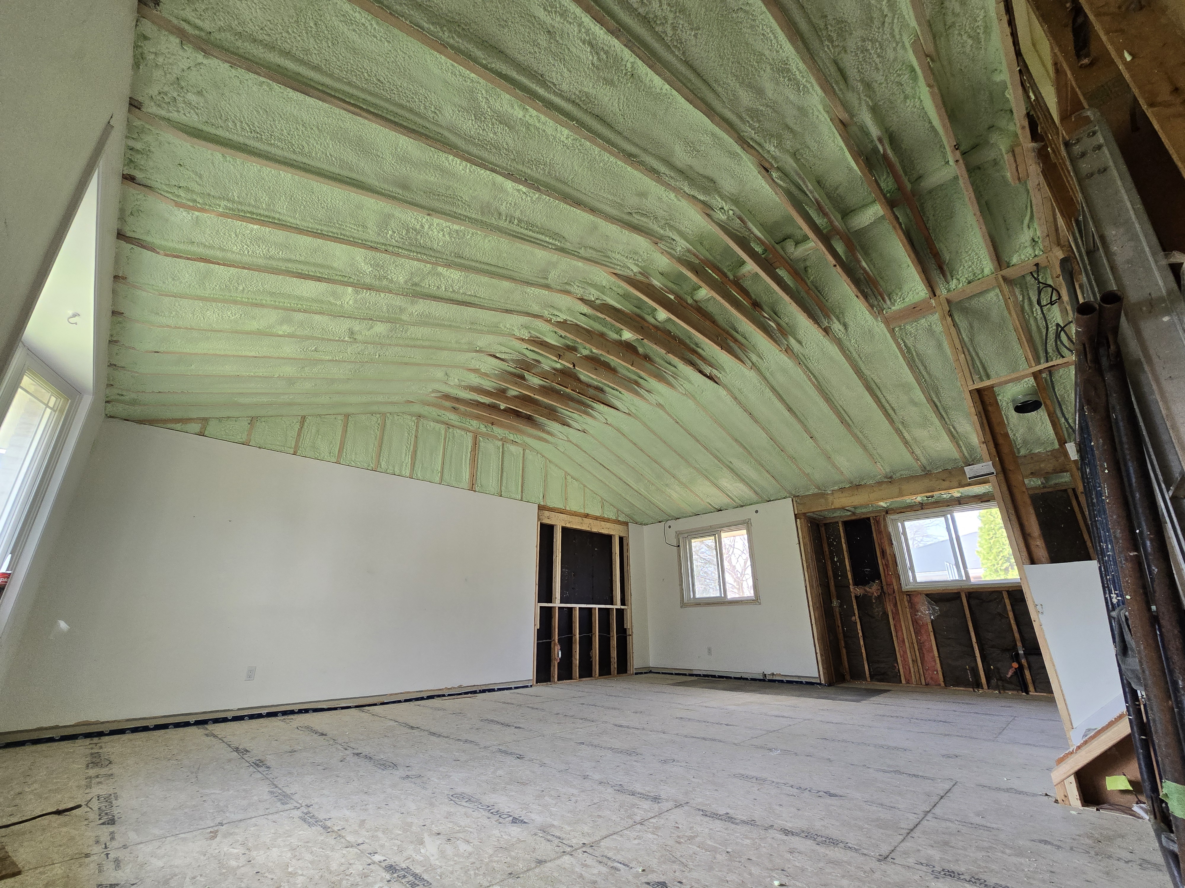 Spray foam applied to vaulted ceiling interior